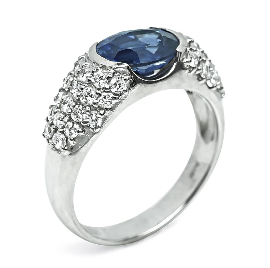 Vintage platinum ring with oval sapphire and round diamond accents