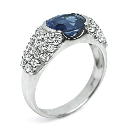 Vintage platinum ring with oval sapphire and round diamond accents